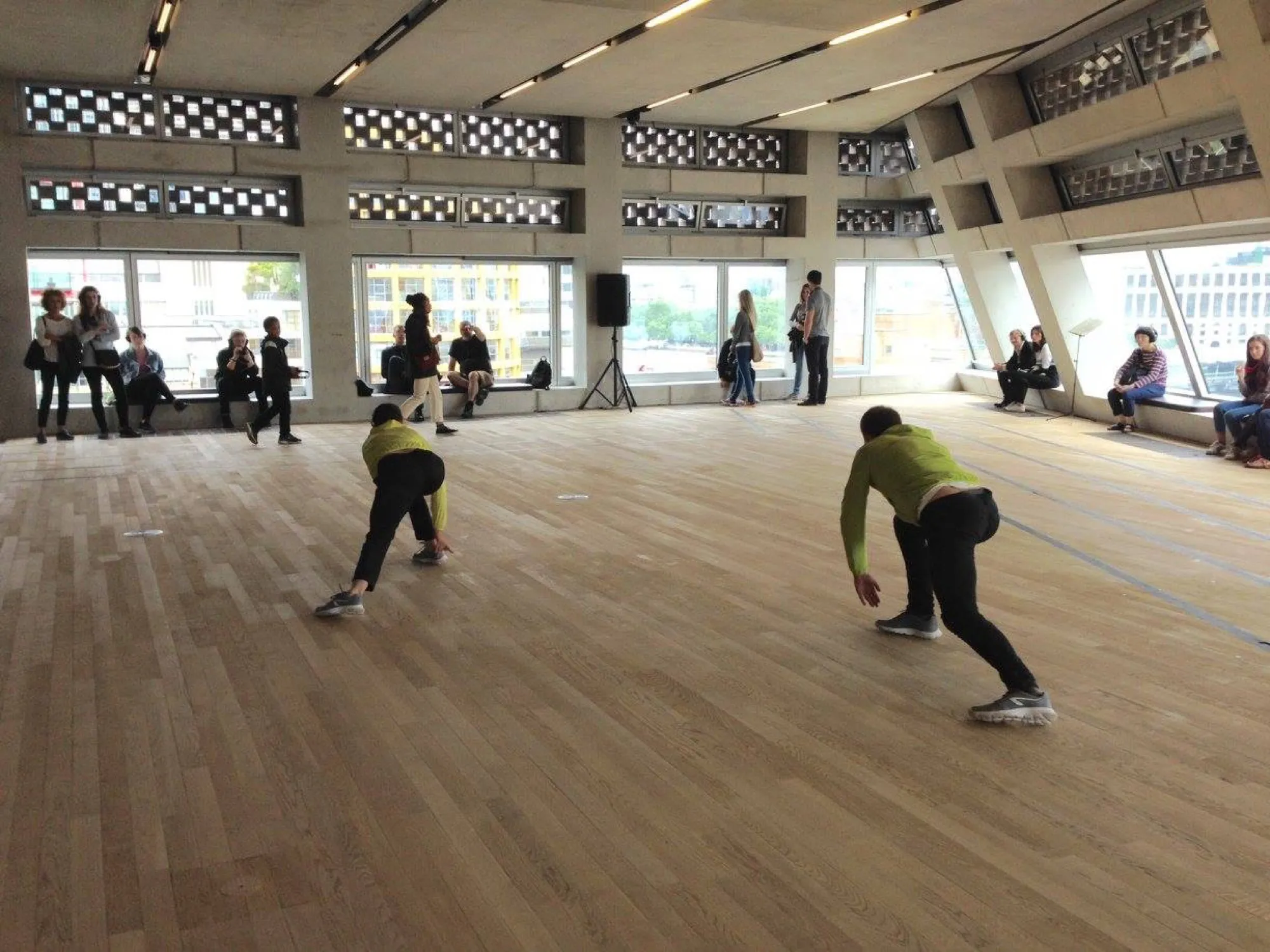 Participants moving in a wide, light-filled room